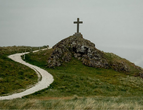 Path leading to a wooden cross